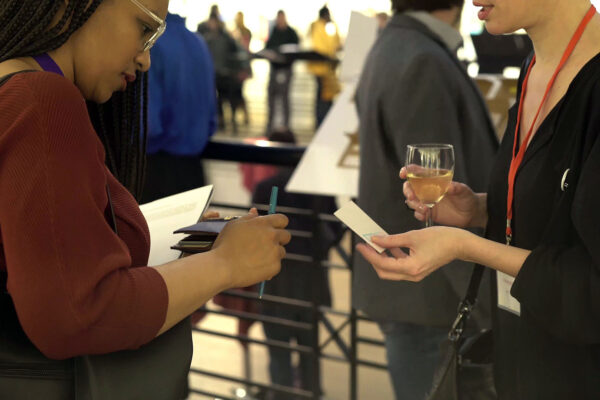 Two womans exchanging business cards. Event Videography by Plasma Media in Montreal